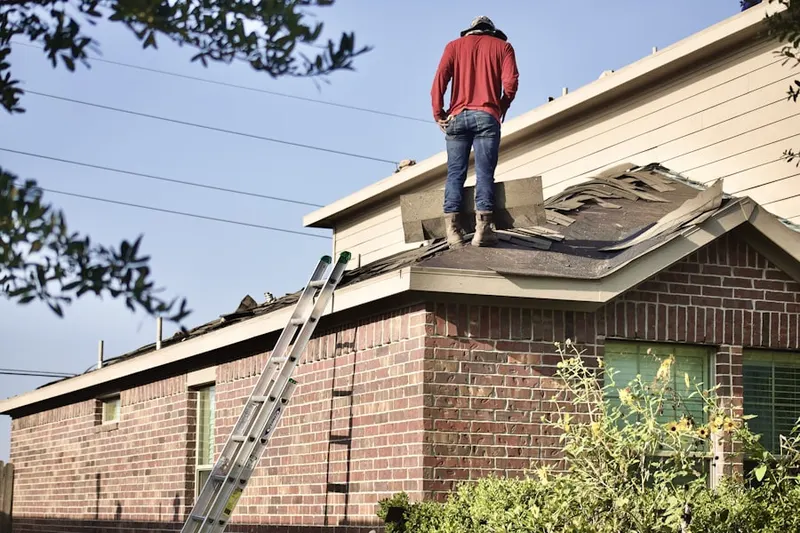 Professional roofer working on a residential roof in Providence